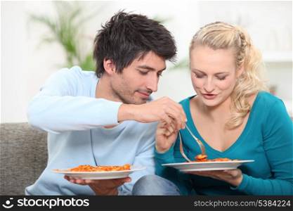 young couple having dinner at home