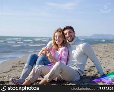Young Couple having fun and making soap bubbles On The Beach at autumn day. young couple enjoying time together at beach