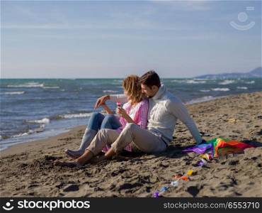 Young Couple having fun and making soap bubbles On The Beach at autumn day. young couple enjoying time together at beach