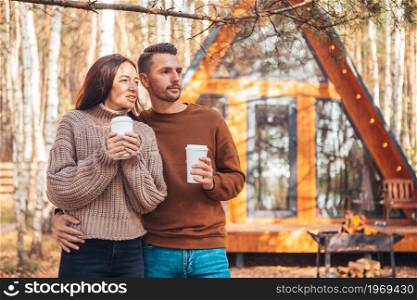 Young couple having fun at autumn warm day. Happy family of two on the terrace in autumn