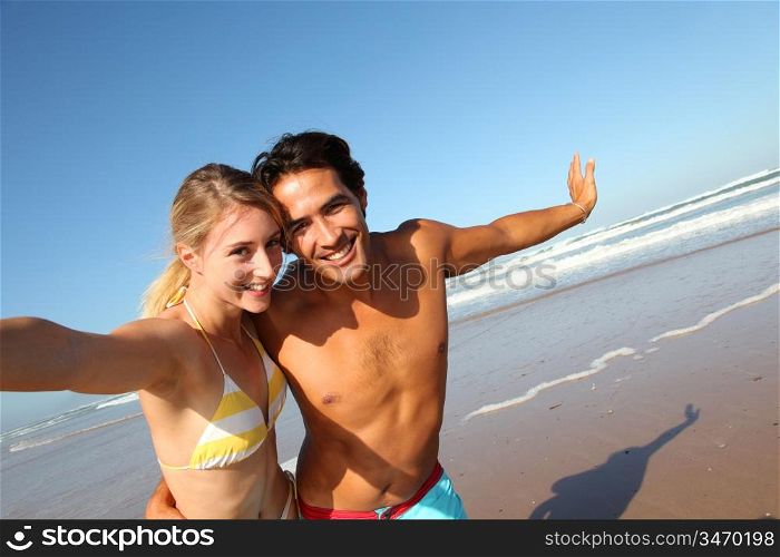 Young couple having fun at the beach