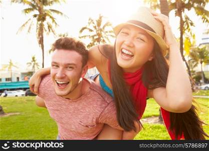 Young Couple Having Fun In Park Together