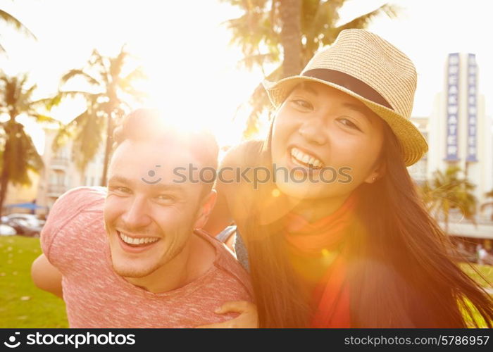 Young Couple Having Fun In Park Together