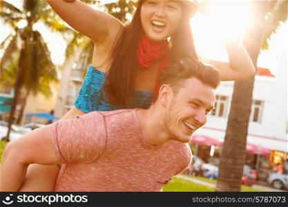 Young Couple Having Fun In Park Together