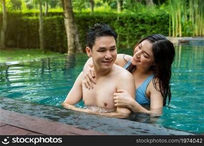 young couple having fun in swimming pool
