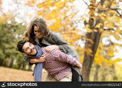 Young couple having fun in the autumn forest
