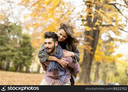 Young couple having fun in the autumn forest