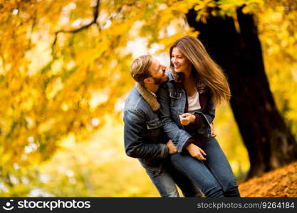 Young couple having fun in the autumn park