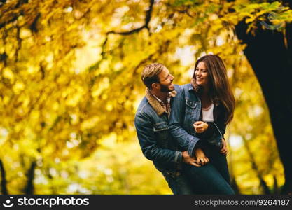 Young couple having fun in the autumn park