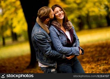Young couple having fun in the autumn park