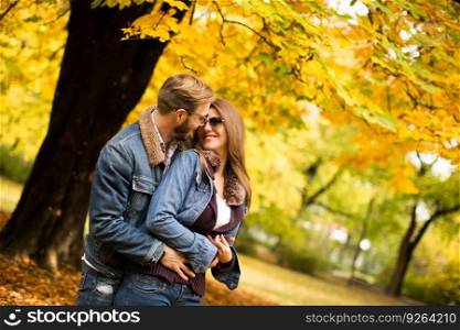 Young couple having fun in the autumn park