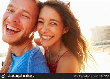 Young Couple Having Fun On Beach Holiday Together