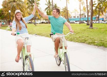 Young Couple Having Fun On Bicycle Ride