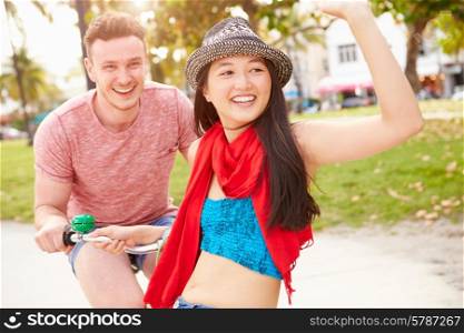 Young Couple Having Fun On Bicycle Ride