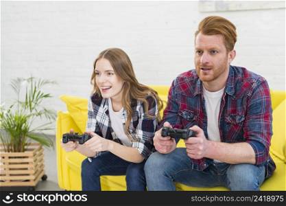 young couple having fun playing videogame home
