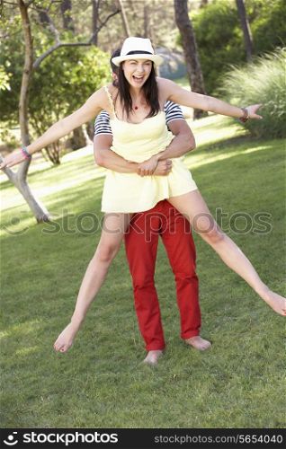 Young Couple Having Fun Together In Garden
