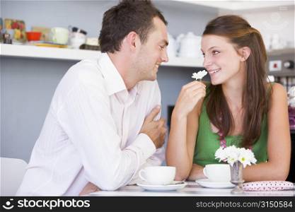 Young couple having tea in a cafeteria