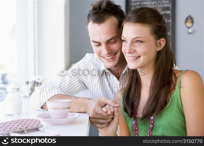 Young couple having tea in a cafeteria