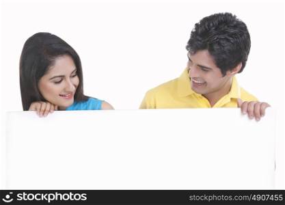 Young couple holding a board