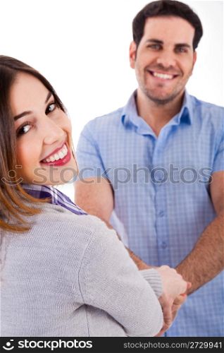 Young couple holding each other and smiling on a isolated white background
