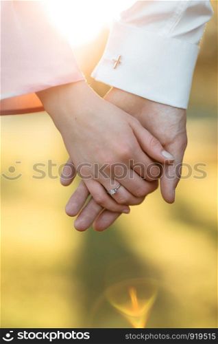 young couple holding hands on the arm ring. young couple holding hands on the arm ring. Close Up view