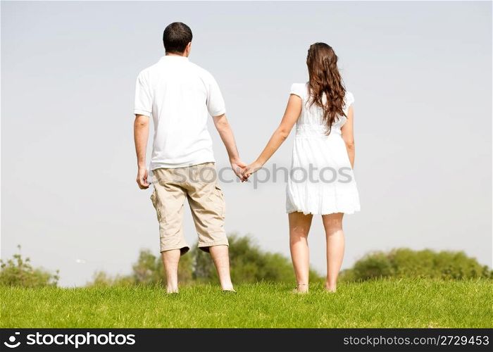 young couple holding hands, outdoor