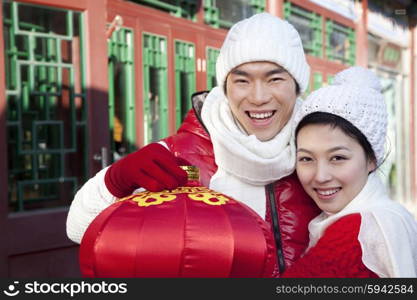 Young couple holding red lantern