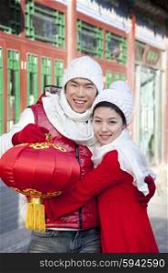 Young couple holding red lantern