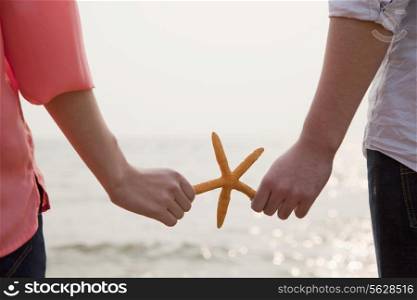 Young Couple Holding Starfish