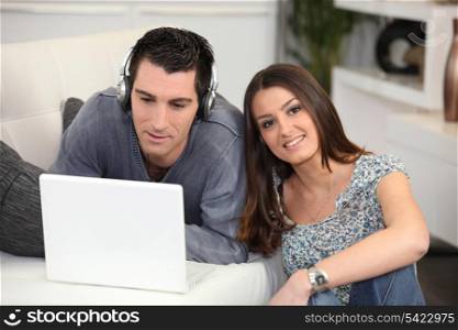 young couple home with laptop
