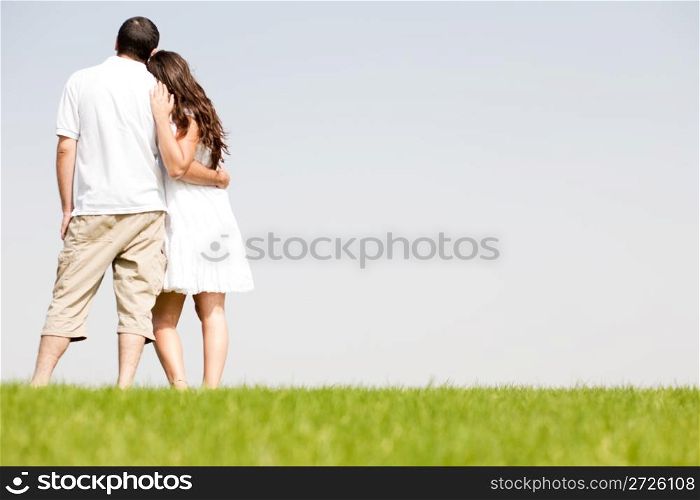 young couple hug, park