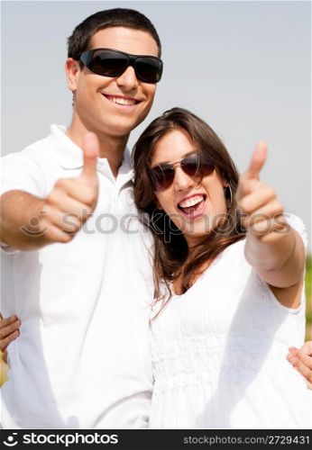Young Couple Hugging and smile, thumbs up