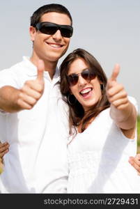 Young Couple Hugging and smile, thumbs up