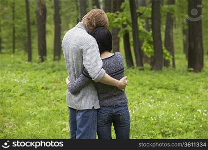 Young Couple Hugging in Forest