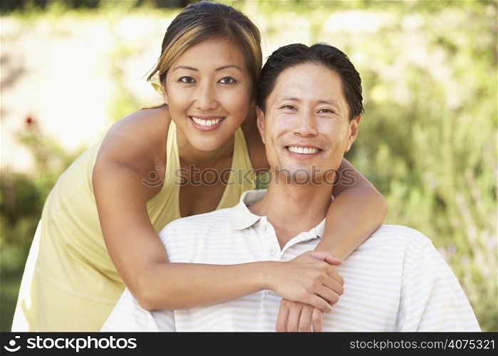 Young Couple Hugging In Garden