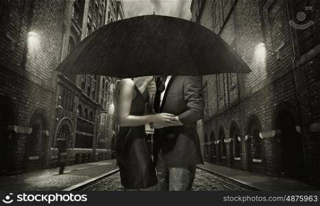Young couple hugging in the heavy rain