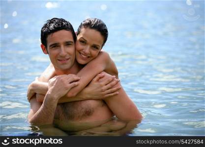 Young couple hugging in the water
