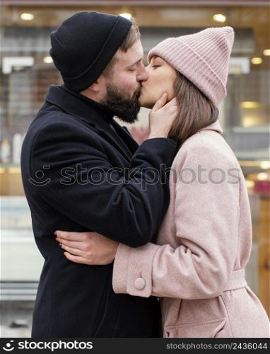 young couple hugging kissing