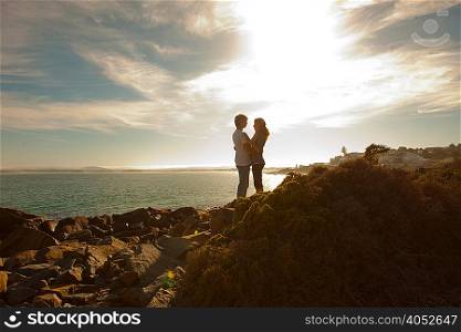 Young couple hugging on coastline
