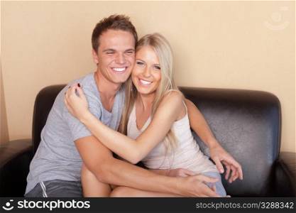 Young couple hugging on couch
