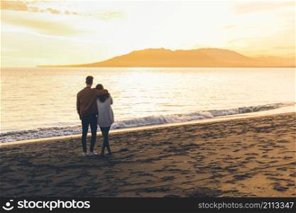 young couple hugging sea shore