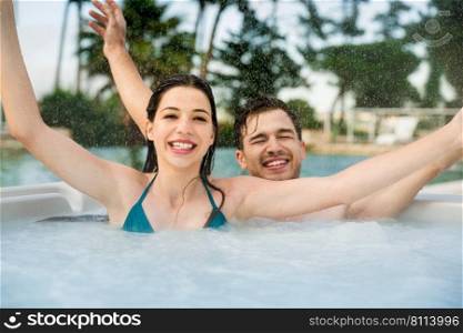 Young couple in a luxury hotel inside a jacuzzi in a rainy day 