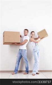 Young couple in a new apartment with boxes