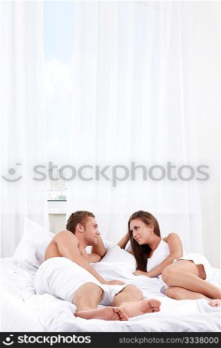 Young couple in bed in the bedroom