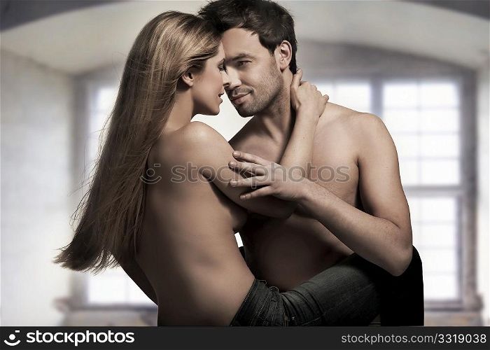 Young couple in blue jeans on nice interior