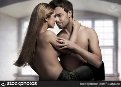 Young couple in blue jeans on nice interior