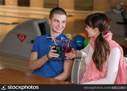 young couple in bowling club having fun together