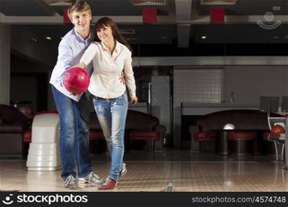 Young couple in bowling club having fun together. Weekend at bowling
