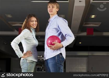 Young couple in bowling club having fun together. Weekend at bowling