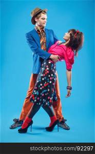 Young couple in colorful old-fashion clothes in pinup style dancing. Also they can represent members of a youth counterculture Stilyagi existed from the late 1940s until the early 1960s in the Soviet Union